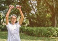 Mature man lifting dumbbell in park Royalty Free Stock Photo