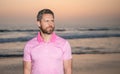 mature man looking away over sea on morning summer beach, copy space, fashion Royalty Free Stock Photo