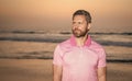 mature man looking away over sea on morning summer beach, copy space, fashion Royalty Free Stock Photo