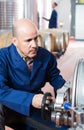 Mature man machinery operator working in winery