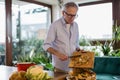 Mature man making compost from leftovers