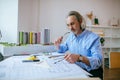 Mature man making drawing in office, designs building Royalty Free Stock Photo