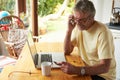 Mature Man Making On Line Purchase Using Credit Card