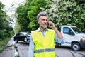 Mature man making a phone call after a car accident. Copy space. Royalty Free Stock Photo