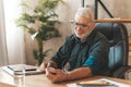 A mature man measures his blood pressure, hypertension in the elderly. Cardiac check at home with a stethoscope Royalty Free Stock Photo