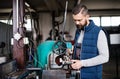 Man mechanic repairing a car in a garage. Royalty Free Stock Photo