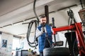 Man mechanic repairing a car in a garage. Royalty Free Stock Photo