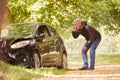 Mature Man Next To Car Crashed Into Tree Inspecting Accident Damage And Calling Emergency Services Royalty Free Stock Photo