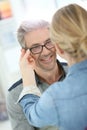 Mature man in optical store trying eyeglasses Royalty Free Stock Photo