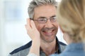 Mature man in optical store trying on eyeglasses Royalty Free Stock Photo