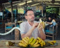 Traveling man ordered a huge portion of fresh bananas at a tropical restaurant