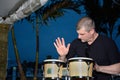 Mature man playing bongos outdoors Royalty Free Stock Photo