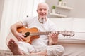 Mature man playing guitar at home Royalty Free Stock Photo