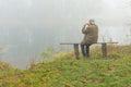 Mature man playing sopilka sitting on a bench Royalty Free Stock Photo