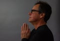 Mature man praying, contemplative, with hands on prayer pose Royalty Free Stock Photo