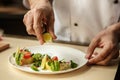 Mature man professional chef cooking meal indoors Royalty Free Stock Photo