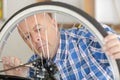 mature man pumping wheel bike