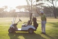 Mature man putting golf club in bag Royalty Free Stock Photo