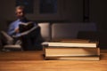 Mature man reading a book in a living room by night Royalty Free Stock Photo