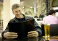 Mature man reading menu card Royalty Free Stock Photo