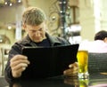 Mature man reading menu card Royalty Free Stock Photo