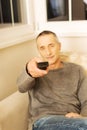 Mature man with remote control Royalty Free Stock Photo