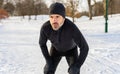 mature man running at winter in park have some breathing difficulties