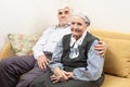 Mature man and senior woman sitting on sofa