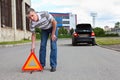 Mature man sets triangle warning sign Royalty Free Stock Photo