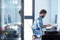 Mature man sitting on chair in front of computer and typing on keyboard while working, businessman working on computer desktop. Royalty Free Stock Photo