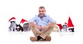 Mature man sitting cross-legged in front of christmas cats