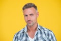 mature man smile with grizzle hair on yellow background