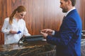 Mature man standing at check-in desk Royalty Free Stock Photo