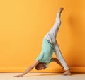 Mature man standing in inverted pyramid yoga pose