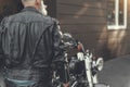 Mature man standing near motorbike