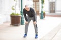 Mature man stopping for a breather after long run Royalty Free Stock Photo