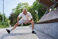 Mature man stretching body and feeling flexible while exercising at the park Royalty Free Stock Photo