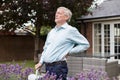 Mature Man Suffering From Backache Whilst Gardening At Home Royalty Free Stock Photo