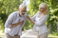 Mature Man Suffering Sudden Chest Pain While Walking With Wife In Park Royalty Free Stock Photo