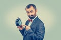 Mature man in suit pointing to his alarm clock Royalty Free Stock Photo