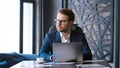 Mature man in a suit typing on a laptop. Young businessman working