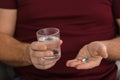 Mature man taking pill, closeup