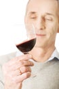 Mature man tasting red wine Royalty Free Stock Photo