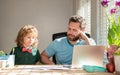 mature man teacher or dad helping kid son with school homework on computer, back to school Royalty Free Stock Photo