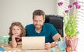 mature man teacher or dad helping kid son with school homework on computer, school Royalty Free Stock Photo