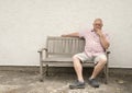 Mature man thinking on a wooden bench Royalty Free Stock Photo