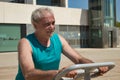 mature man trying hard doing sports with a sports machine on the street Royalty Free Stock Photo