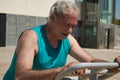 mature man trying hard training on the street with sports machine Royalty Free Stock Photo