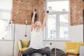 Mature man using dumbbells and fitball for workout at home Royalty Free Stock Photo