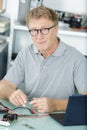 Mature man using laptop cables Royalty Free Stock Photo